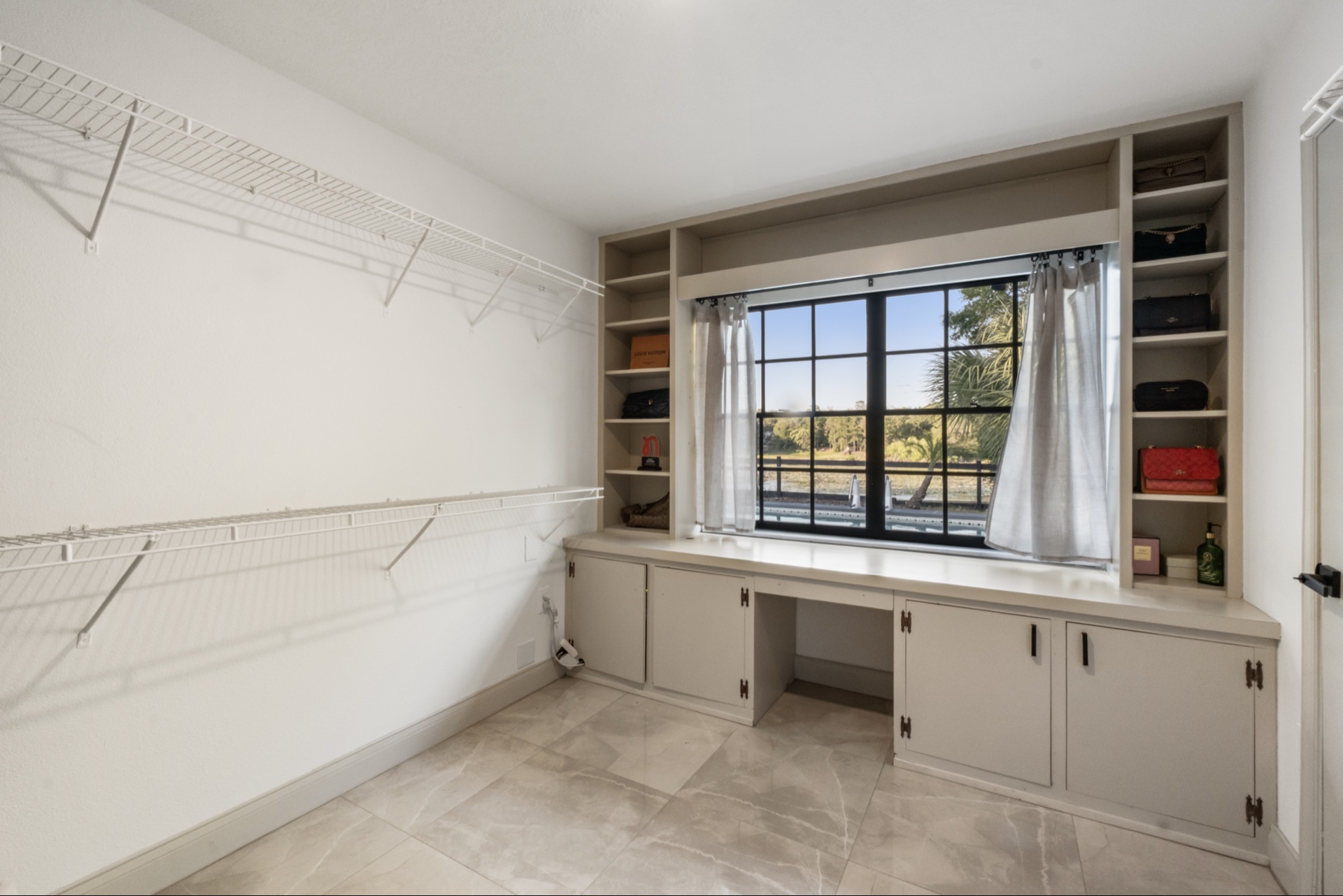 Oversized Walk-In Closet — Built-Ins, Vanity & Pool View