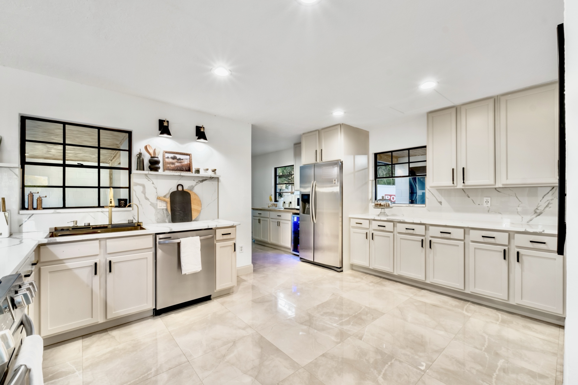 Custom Cabinets, Gold Fixtures & Quartz Backsplash